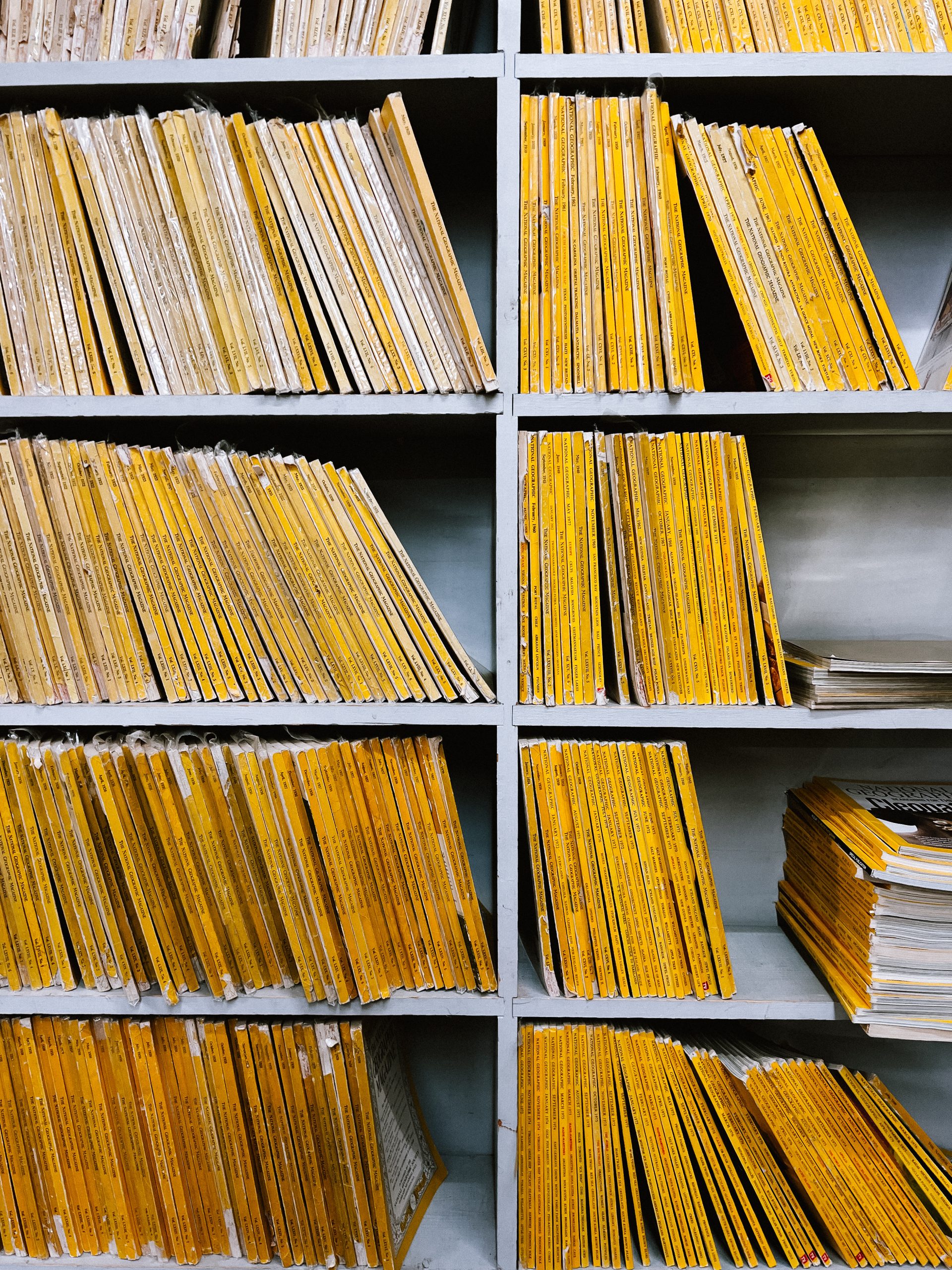 Bookshelves with rows of dull annual reports with yellow spines